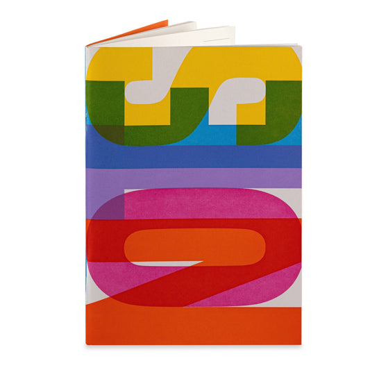 A colourful letterpress printed notebook that reads 'NOTES' in vibrant shades of yellow, blue, red, and green.