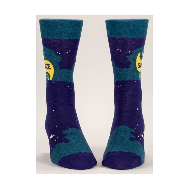 Purple and blue socks with white spots all over. The text on the middle of the socks reads “Big Space Nerd”