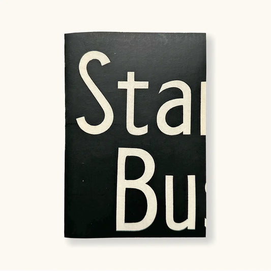 A black linen notebook made form vintage bus destination blinds. The notebook is black with the letters 'Sta Bu' Written on the front. Each notebook is slightly different.