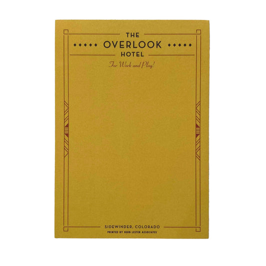 A yellow notepad with 'The Overlook Hotel' written at the top 