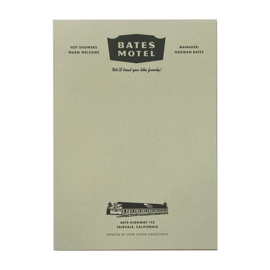 A light green notepad with 'Bates Motel' written at the top. 