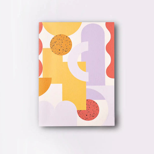 A rectangular notebook with an abstract art print of geometric shapes in orange, yellow, pink, purple, and white colours.