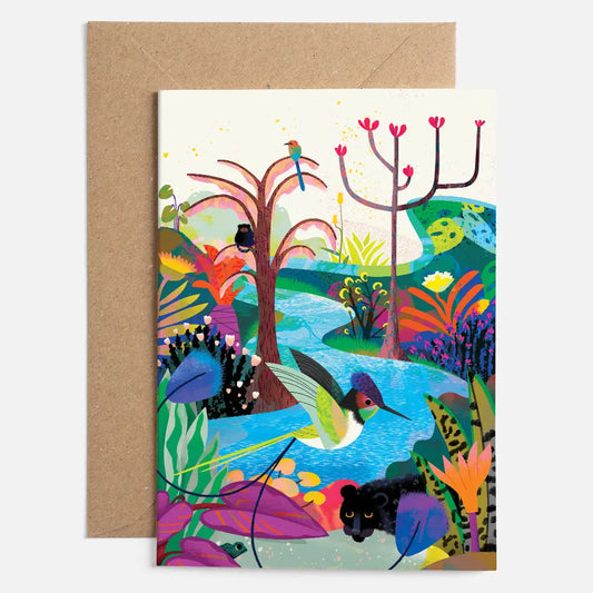 A lovely colourful card with the image of a stream, plants, 2 different birds, a panther and a monkey on the front 