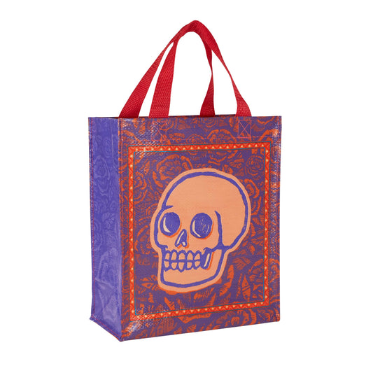 A purple ag with red handles and an image of a skull surrounded by roses on the front.