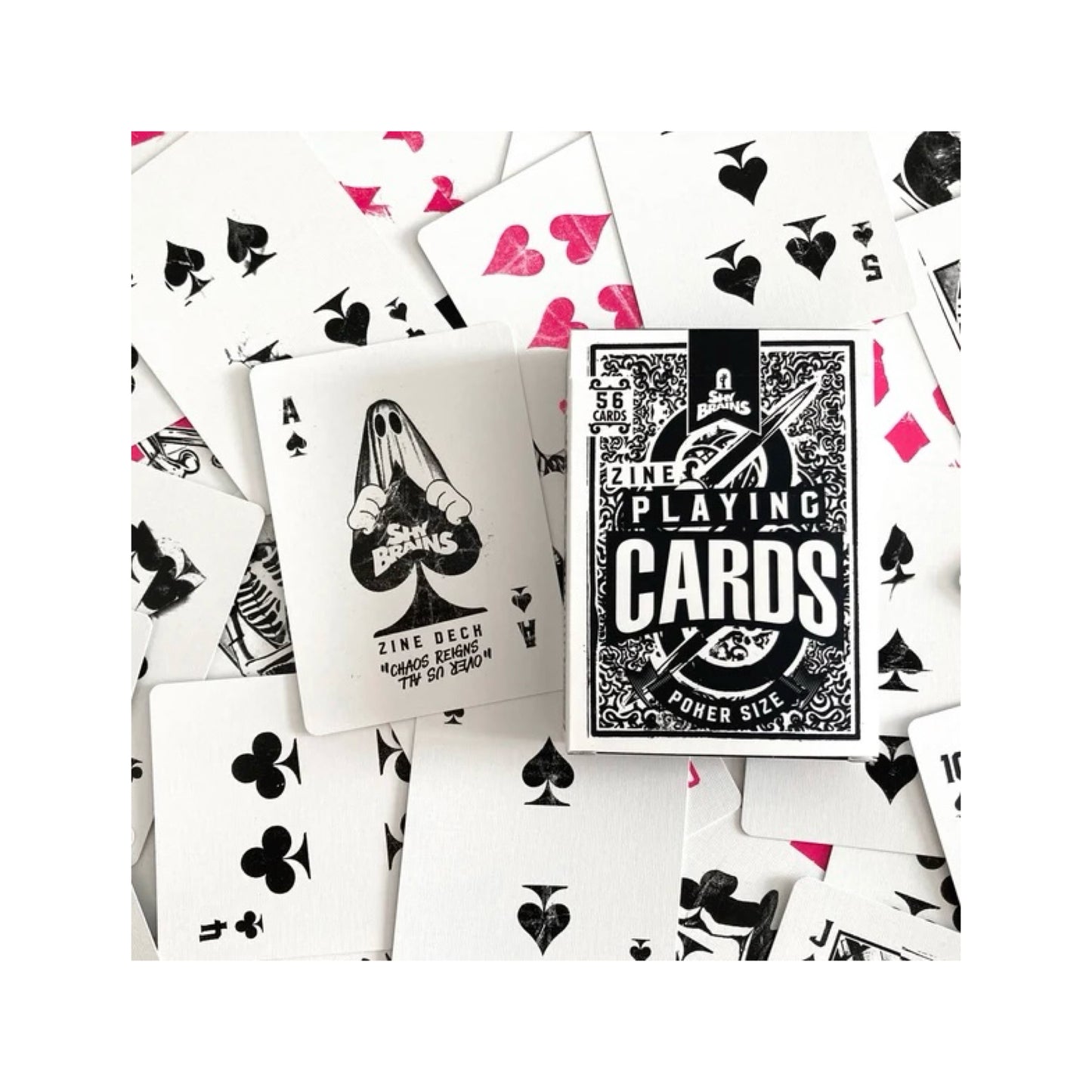 A pack of Zine playing cards with funky designs and the ace with 'Shy brains' written in the middle being held by a ghost