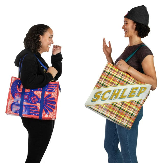 Two women wearing Blue Q bags having a conversation