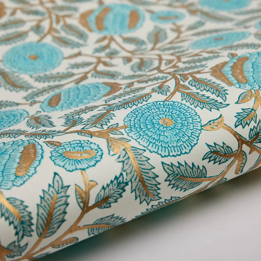 Close-up of floral patterned cotton wrapping paper with turquoise and gold colours.