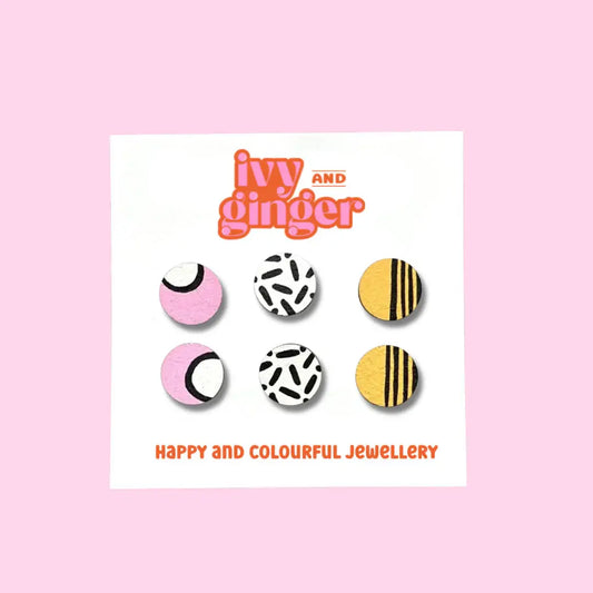Wooden stud earrings with colourful striped patterns on displayed on a white backing card.