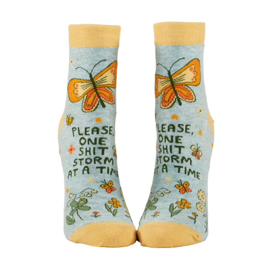 A pair of blue socks with text and butterfly patterns, designed for women's shoe size UK 4-8.