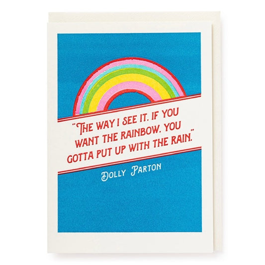 A blue card with a rainbow on the front -. The text on the cards reads: ' The way i see it. If you want the rainbow. You gottta put up with the rain. - Dolly Parton'