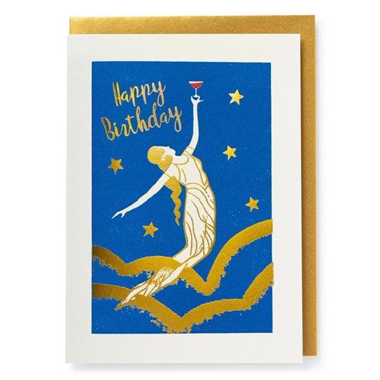 A white and blue card with a gold lady and stars on the front. The lady on the card is holding up a drink in a long stemmed glass and the text on the card reads: ' Happy Birthday'