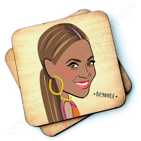 Image shows a wooden drinks coaster with a cartoon graphic of Beyonce on the front 