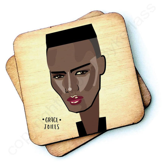 Image shows a wooden drinks coaster with a cartoon graphic of Grace Jones on the front 