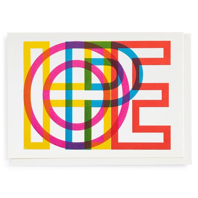 A white card with the word ' HOPE' spelt out on the front. The letters are yellow, pink, blue and red and they overlap to make a lovely print.