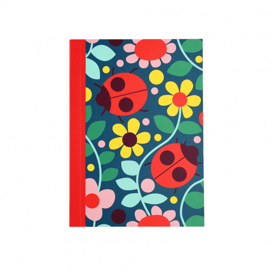 Small notebook with ladybirds and yellow and pink flowers on the front.
