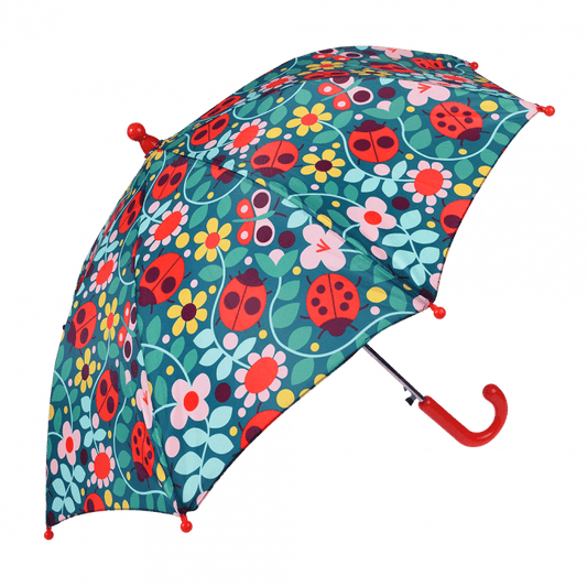 An open umbrella with a red handle and a floral ladybird print all over.