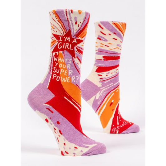 Blue Q socks with a red star and colourful lines. The text on the socks reads ‘I’m a girl what's your superpower?’