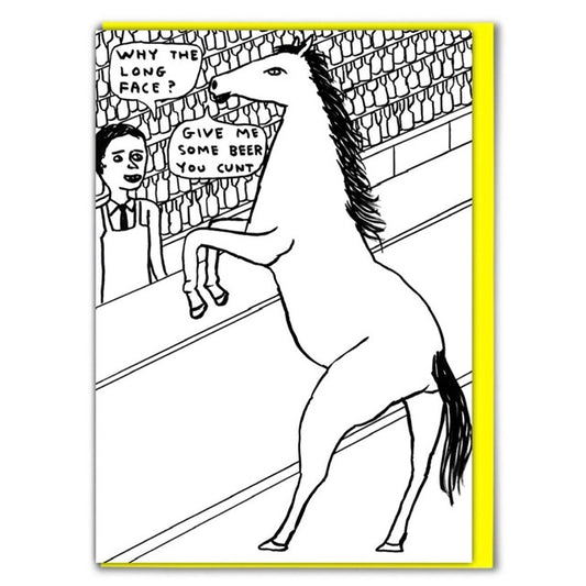 A white card with a drawing on the front of a horse standing Infront of a bar talking to the server. There are 2 speech bubbles, One coming from the server that reads: ' Why the long face? and another coming from the horse that reads: ' Give me some beer you cunt'