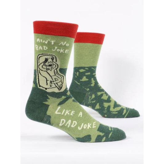 Green Blue Q socks that have a man relaxing in an armchair on them with text saying 'ain't no bad joke like a dad joke'