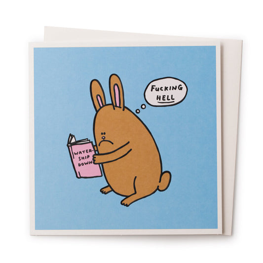 A blue card with a cartookn rabbit on the front that is reading Watership down. There is a speach bubble coming from that rabbit that reads: Fucking HELL