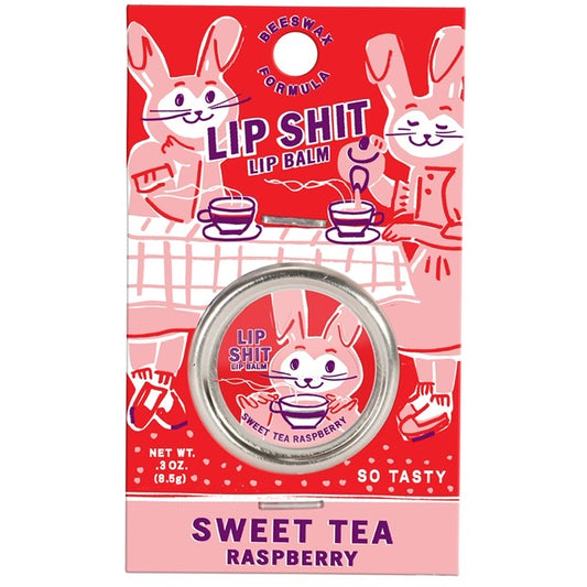 A Blue Q lip shit tin encased in a red cardboard packaging. The text reads: 'Lip shit lip balm -Sweet tea raspberry'