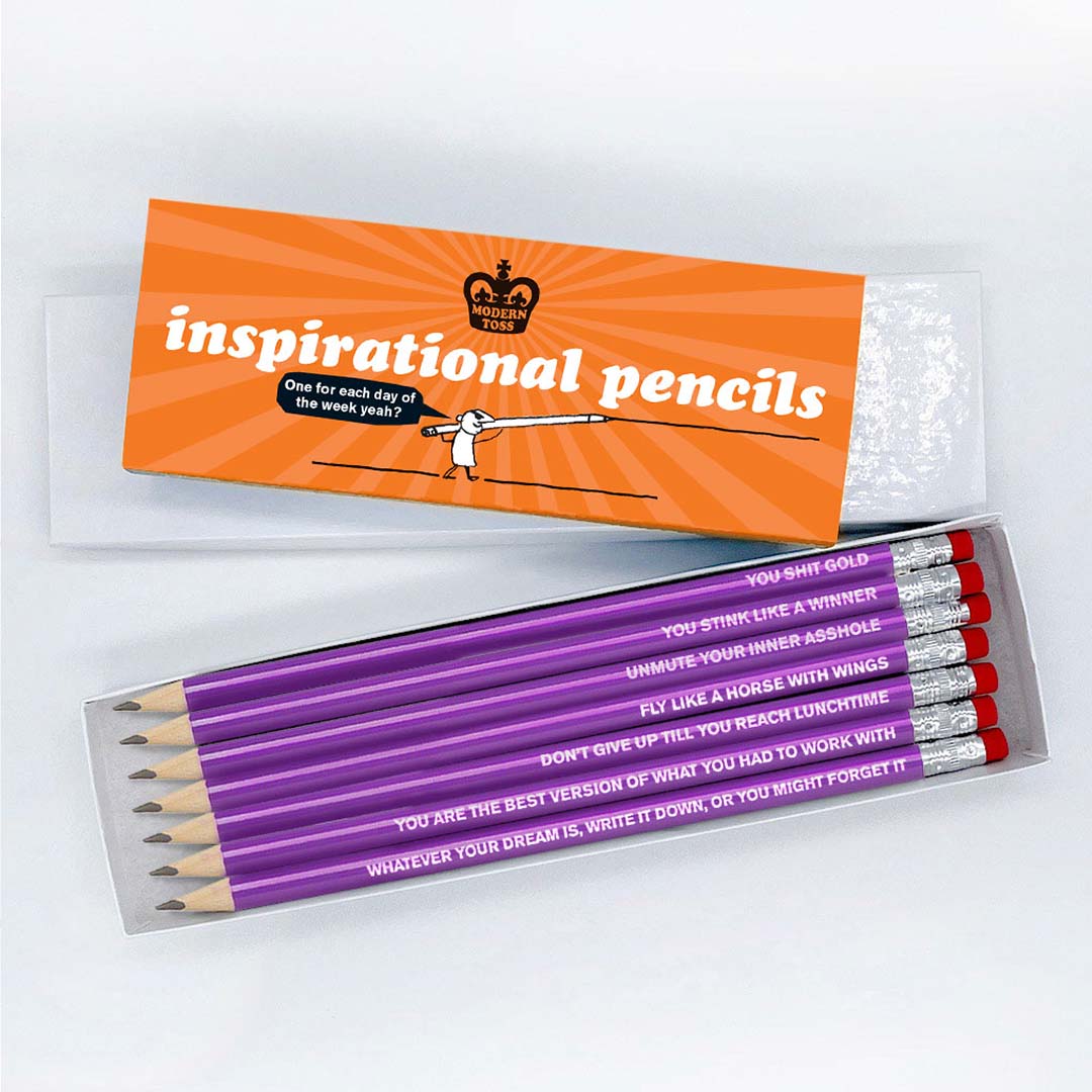 A white box with a orange cardboard slip around that reads: Inspirational pencils one for each day one the week yeah? Infront is an open box of pencils that read: You shit gold, You stink like a winner, Unmute your inner asshole, You are the best version of what you had to work with, Fly like a horse with wings, Whatever your dream is, write it down, or you might forget it and Don't give up till you reach lunchtime.