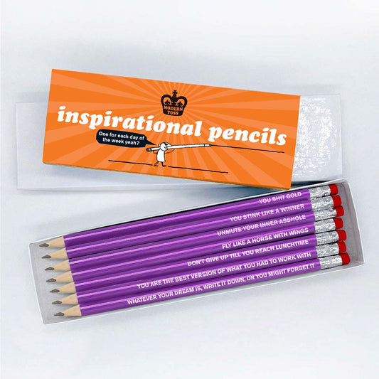 A white box with a orange cardboard slip around that reads: Inspirational pencils one for each day one the week yeah? Infront is an open box of  pencils that read: You shit gold, You stink like a winner, Unmute your inner asshole, You are the best version of what you had to work with, Fly like a horse with wings, Whatever your dream is, write it down, or you might forget it and Don't give up till you reach lunchtime.