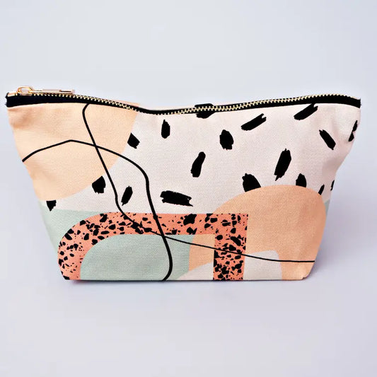 A cosmetic bag with light pink, light green and light orange funky shapes and lines on