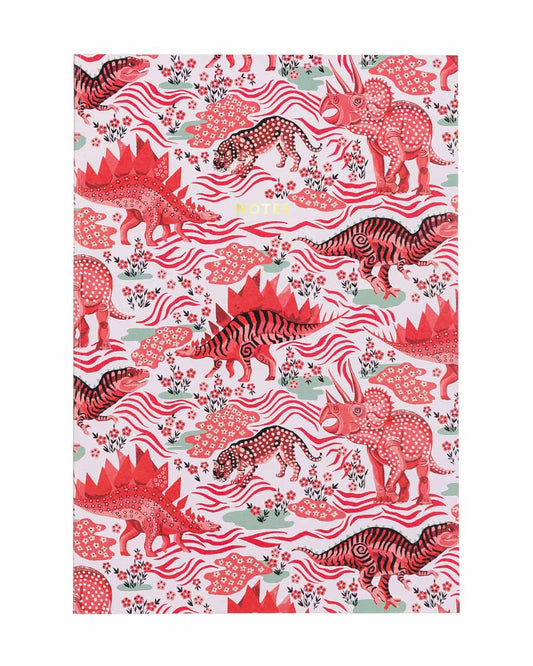 A pink notebook with different red dinosaurs and floral patterns on the front. The text on the notebook reads: notes