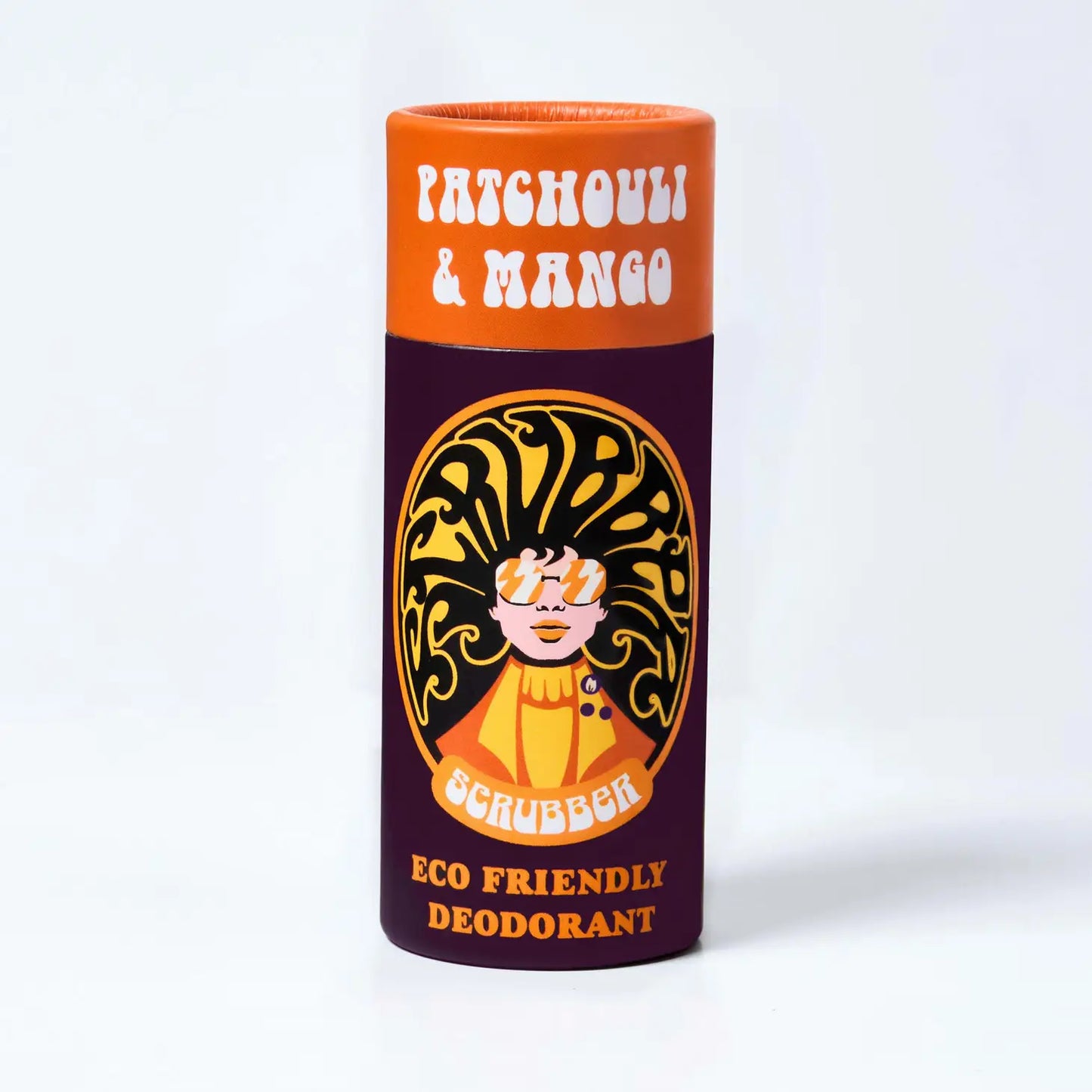 A Orange and maroon cardboard tube containing eco friendly deodorant. In the middle is an image of a woman wearing sunglasses and her hair forms the word 'scrubber' The text on the tube reads: 'Patchouli & mango - scrubber - eco friendly deodorant'