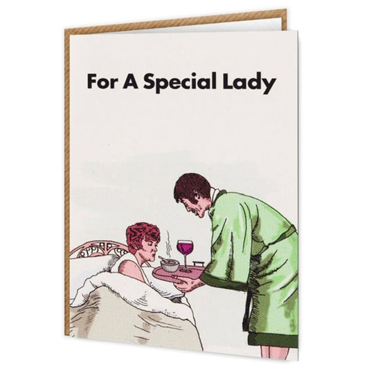 A white card with the image of a woman in bed being brought a tray of red wine and cigarettes. The text on the card reads: For A special lady