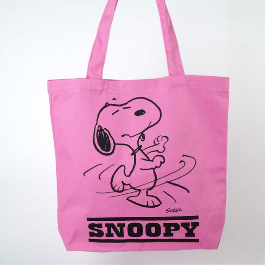 A pink tote bag with a graphic of Snoopy dancing on the front. The text on the bag reads: Snoopy