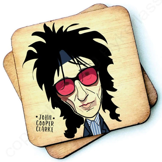 Image shows a wooden drinks coaster with a cartoon graphic of John Cooper Clarke  on the front