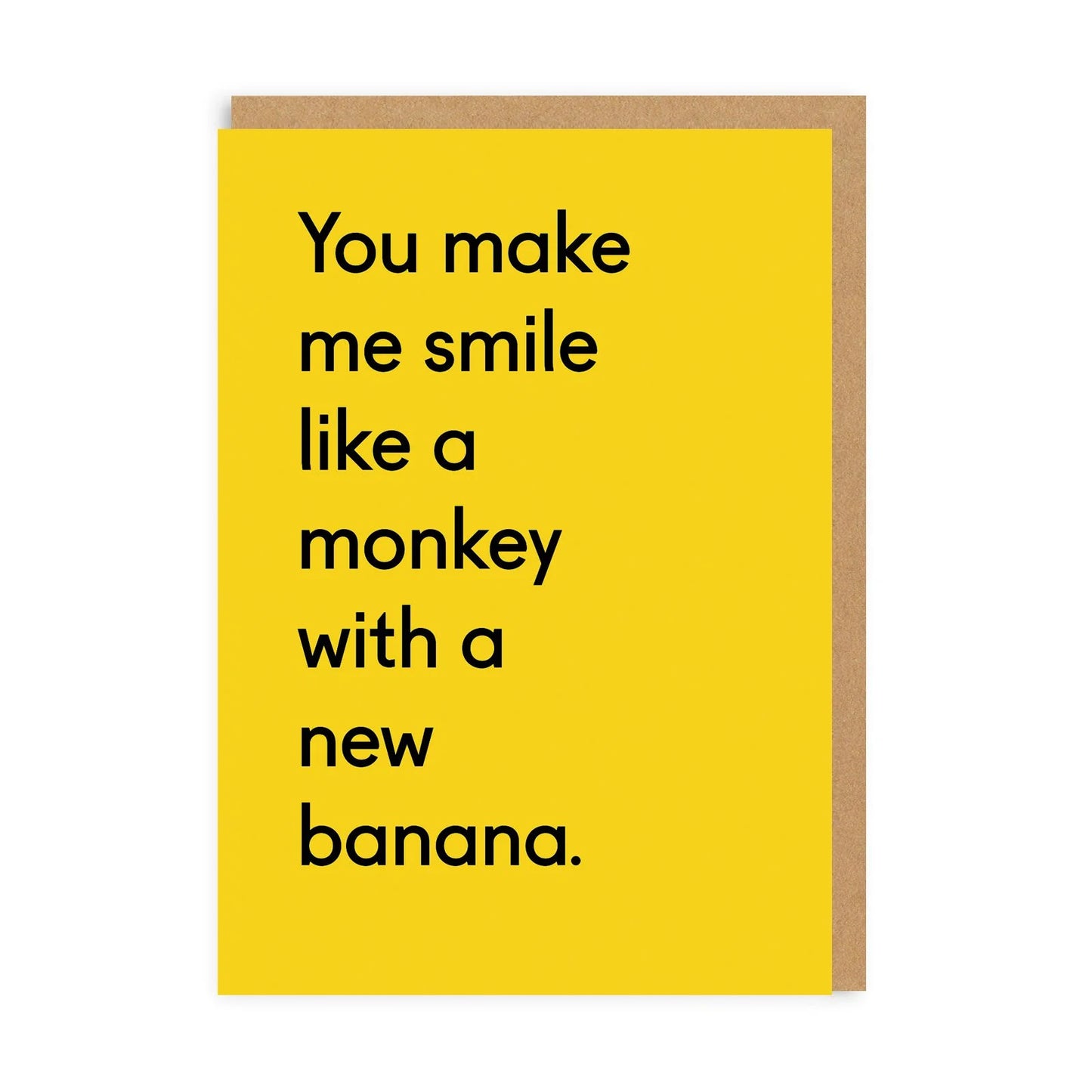 A bright yellow card with text on the front that reads: You make me smile like a monkey with a new banana