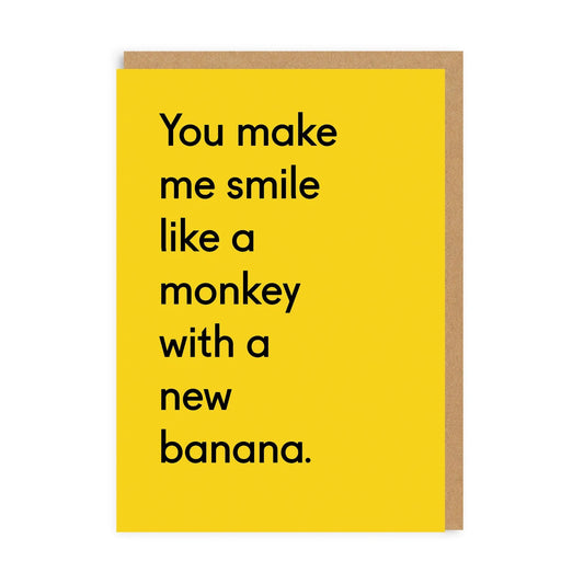 A bright yellow card with text on the front that reads: You make me smile like a monkey with a new banana 