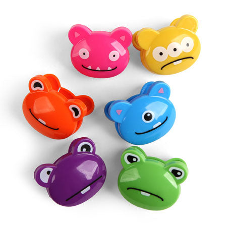 6 Different bag clips shaped like monstors faces. They are Pink, red, purple, green, blue and yellow.