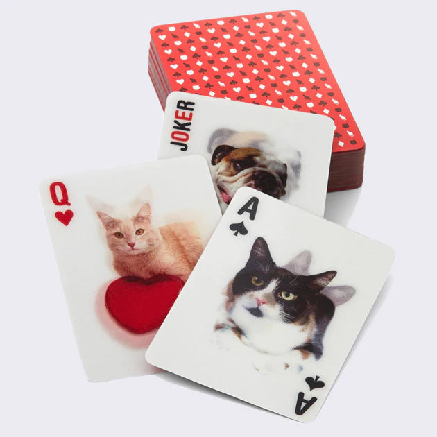 3 lenticular card playing cards with a dog joker on top of a deck of cards.