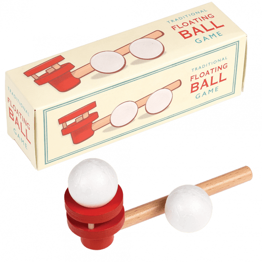 A beige cardboard box with a red, wooden floating ball game infront of it. The text on the box reads: Traditional floating ball game