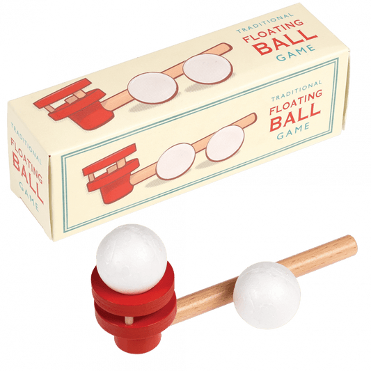 A beige cardboard box with a red, wooden floating ball game infront of it. The text on the box reads: Traditional floating ball game 
