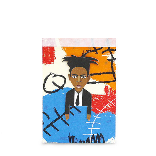 A paper sketch pad with graphic of artist Basquiat and removable paper bookmark tucked into a slit on the front cover