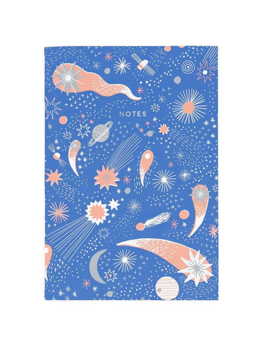 A blue notebook with pictures of shooting stars and planets all over. The text on the notebook reads: notes