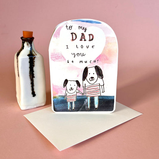 Greeting card with dogs and 'to my dad, I love you so much' text on a pink and blue background.