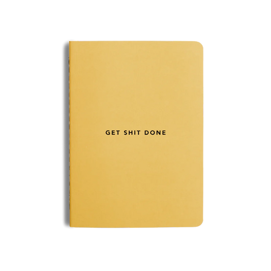 A yellow notebook with the text 'GET SHIT DONE' printed on the cover.
