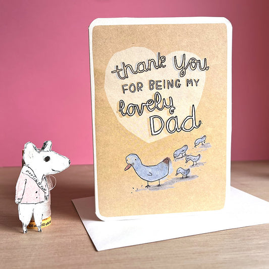 Greeting card with heart and text 'thank you for being my lovely Dad' on a gold background.