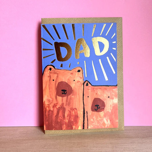 Greeting card with bear illustration and 'DAD' text on blue background