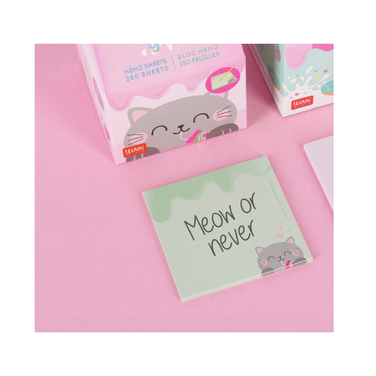 Some of the memo sheets laid out in front of the packaging. The memo sheet reads 'Meow or never’.