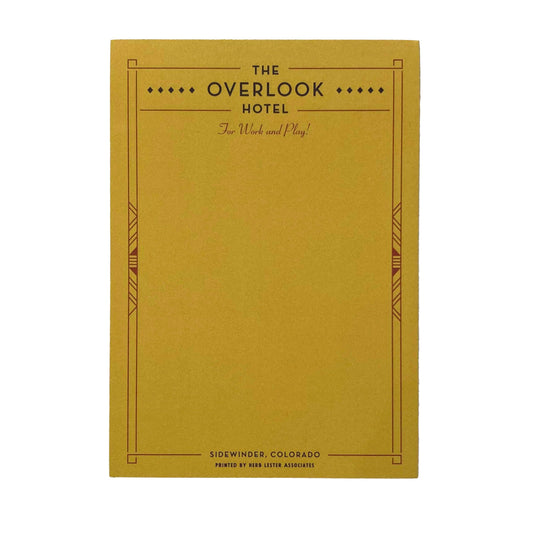 A yellow notepad with 'The Overlook Hotel' written at the top