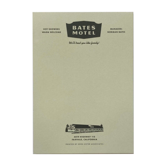 A light green notepad with 'Bates Motel' written at the top.