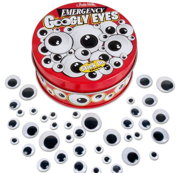 A red tin of emergency googly eyes that is surrounded by lots of different sized googly eyes. 