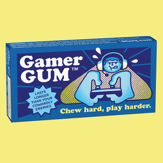 Blue Q gum box with someone playing video games on the front. The text reads 'Gamer gum, chew hard play harder'